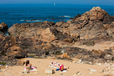 Group of people on rocks at beach