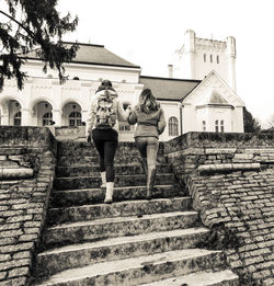People standing on steps against sky