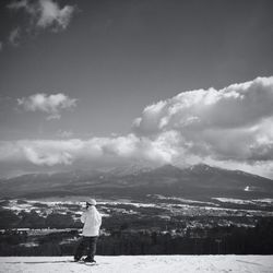 Full length of man on snow covered landscape against sky