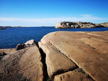 Scenic view of beach against blue sky