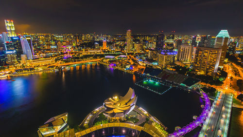 High angle view of illuminated buildings against sky at night