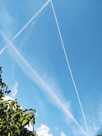 Low angle view of vapor trail against blue sky