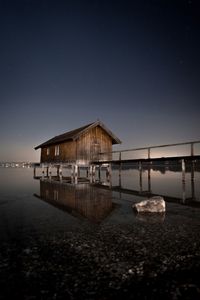 Scenic view of lake against sky at night