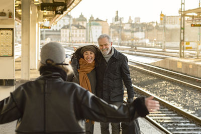 People greeting on train station platform