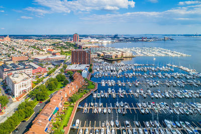 High angle view of buildings by sea against sky