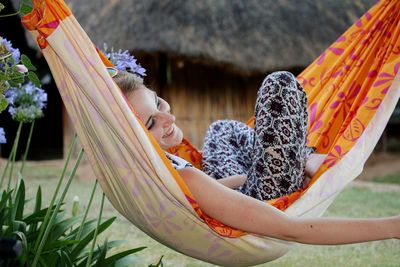 Smiling woman lying on hammock