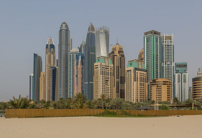 Modern buildings in city against clear sky