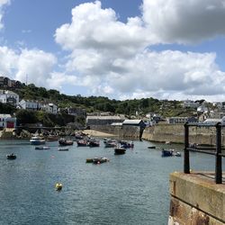 Boats in river against buildings in city