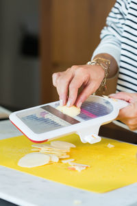 Woman slicing apples. close up of woman hands cutting apple for pie