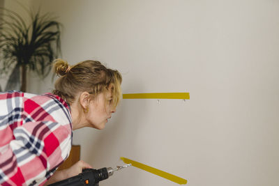 Woman with electric drill