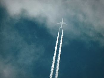 Low angle view of airplane flying in sky