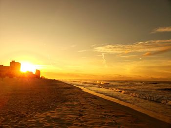 Scenic view of beach against sky during sunset