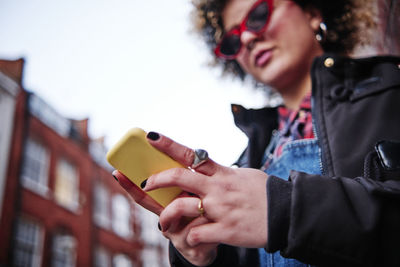 Woman using mobile phone during vacations at chinatown