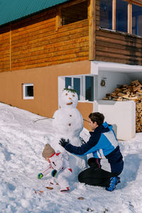 Low section of woman standing on snow