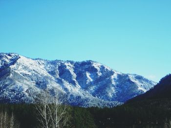 Low angle view of mountain against clear blue sky