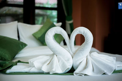 Close-up of white paper on bed at home