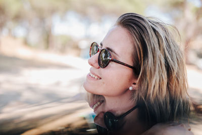 Close-up portrait of young woman wearing sunglasses