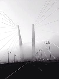 Low angle view of suspension bridge against sky