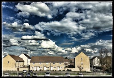 Buildings against cloudy sky