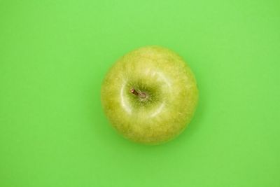 Close-up of apple against green background