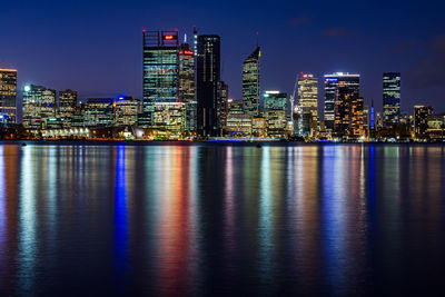 Illuminated city at waterfront
