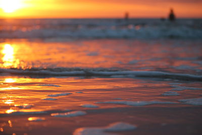 Close-up of sea against sunset sky