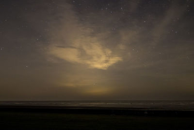 Scenic view of sea against sky at night