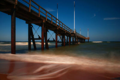 Pier over sea against sky