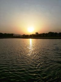Scenic view of lake against sky during sunset