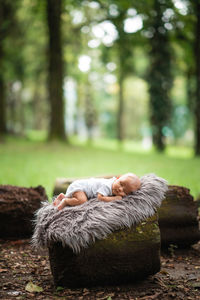 Low section of woman sitting on field