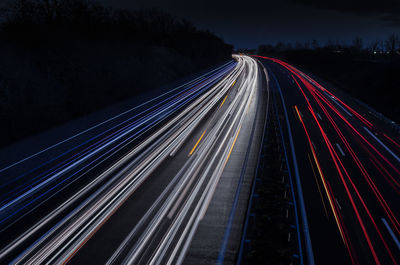 High angle view of light trails on road at night