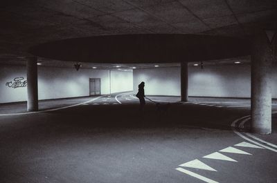 Rear view of silhouette woman walking in corridor