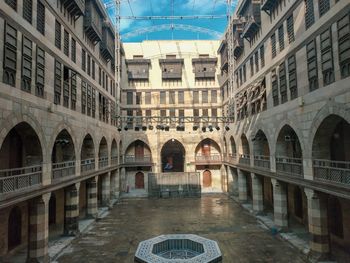 Arch bridge over canal amidst buildings in city