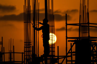 Silhouette of construction worker at sunset