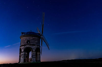 Low angle view of tower against sky at night