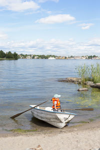 Boat sailing in lake against sky