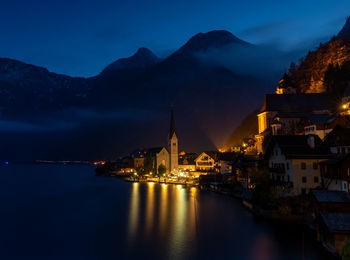 Illuminated buildings in hallstatt at night