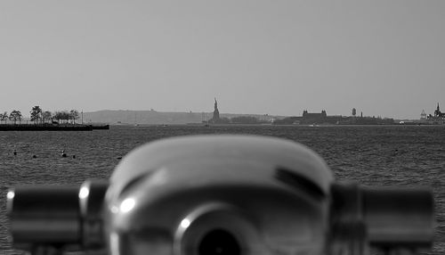 Close-up of car against sea against clear sky