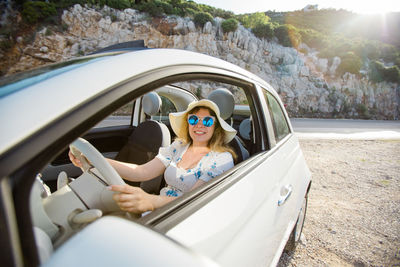 Portrait of smiling woman in car