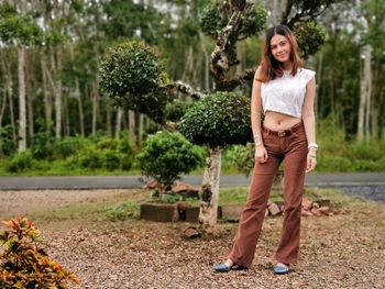 Portrait of smiling young woman standing outdoors