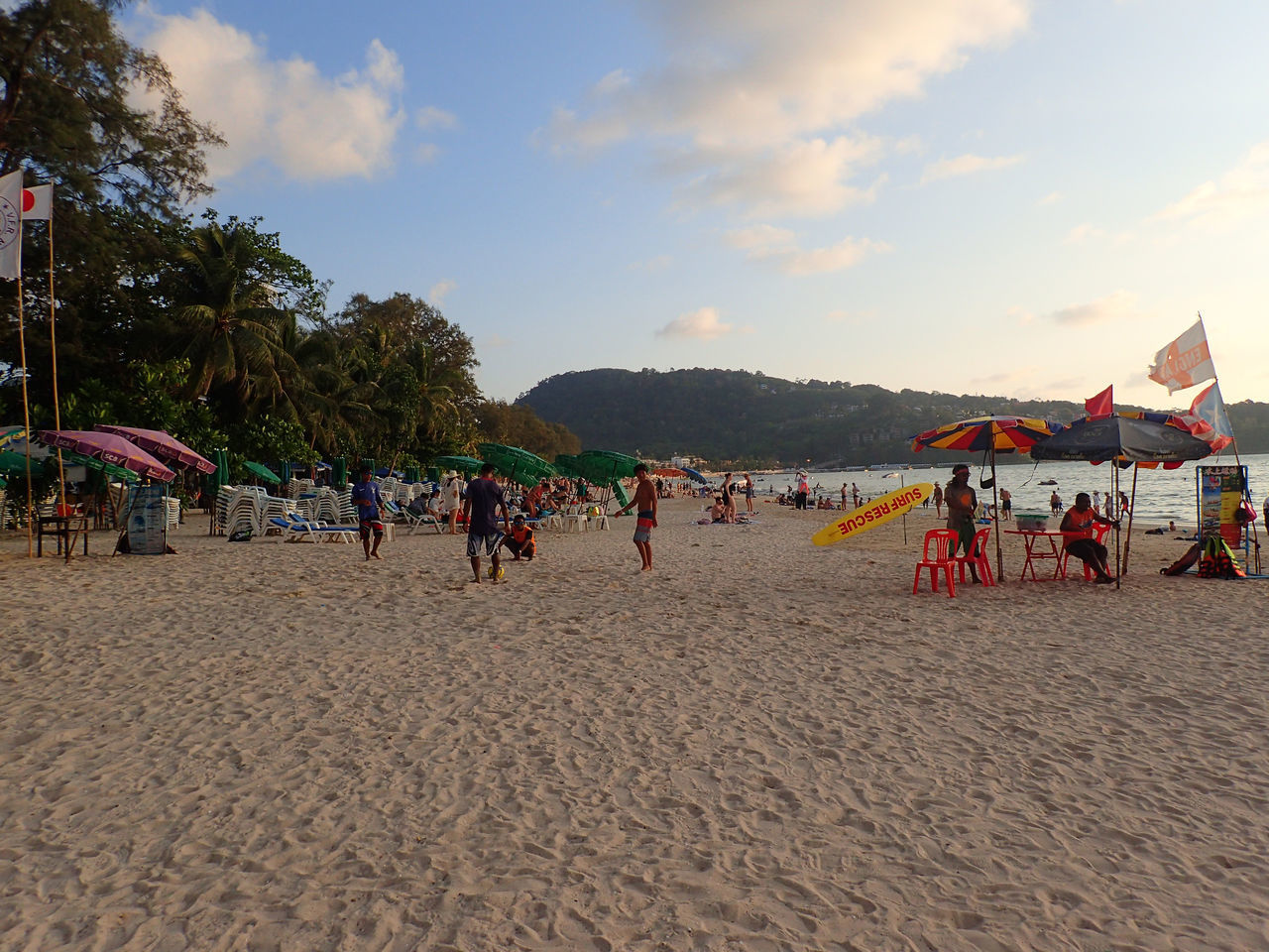 GROUP OF PEOPLE ON BEACH AGAINST SKY