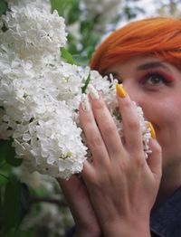 Close-up of woman holding flower