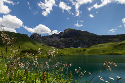 Scenic view of lake and mountains against sky