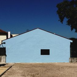 Low angle view of built structure against blue sky