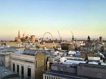 Buildings in city against clear sky