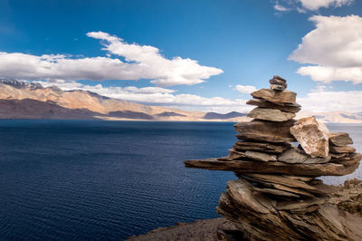 Scenic view of sea and mountains against sky