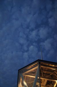 Low angle view of building against cloudy sky