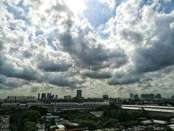 Cityscape against cloudy sky