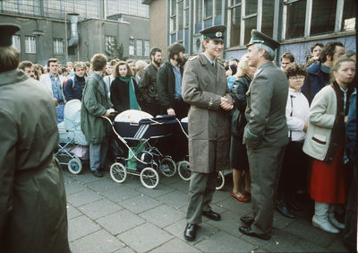 Group of people standing on street in city