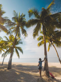 Rear view of man on beach against sky